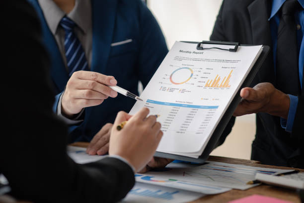 The sales department is having a monthly summary meeting to bring it to the department manager, they are verifying the correctness of the documents that are prepared before bringing in to the manager