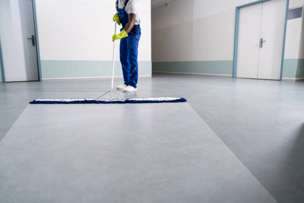 Young Man Cleaning The Floor With Mop In Office Young Man Cleaning The Floor With Mop In Office
